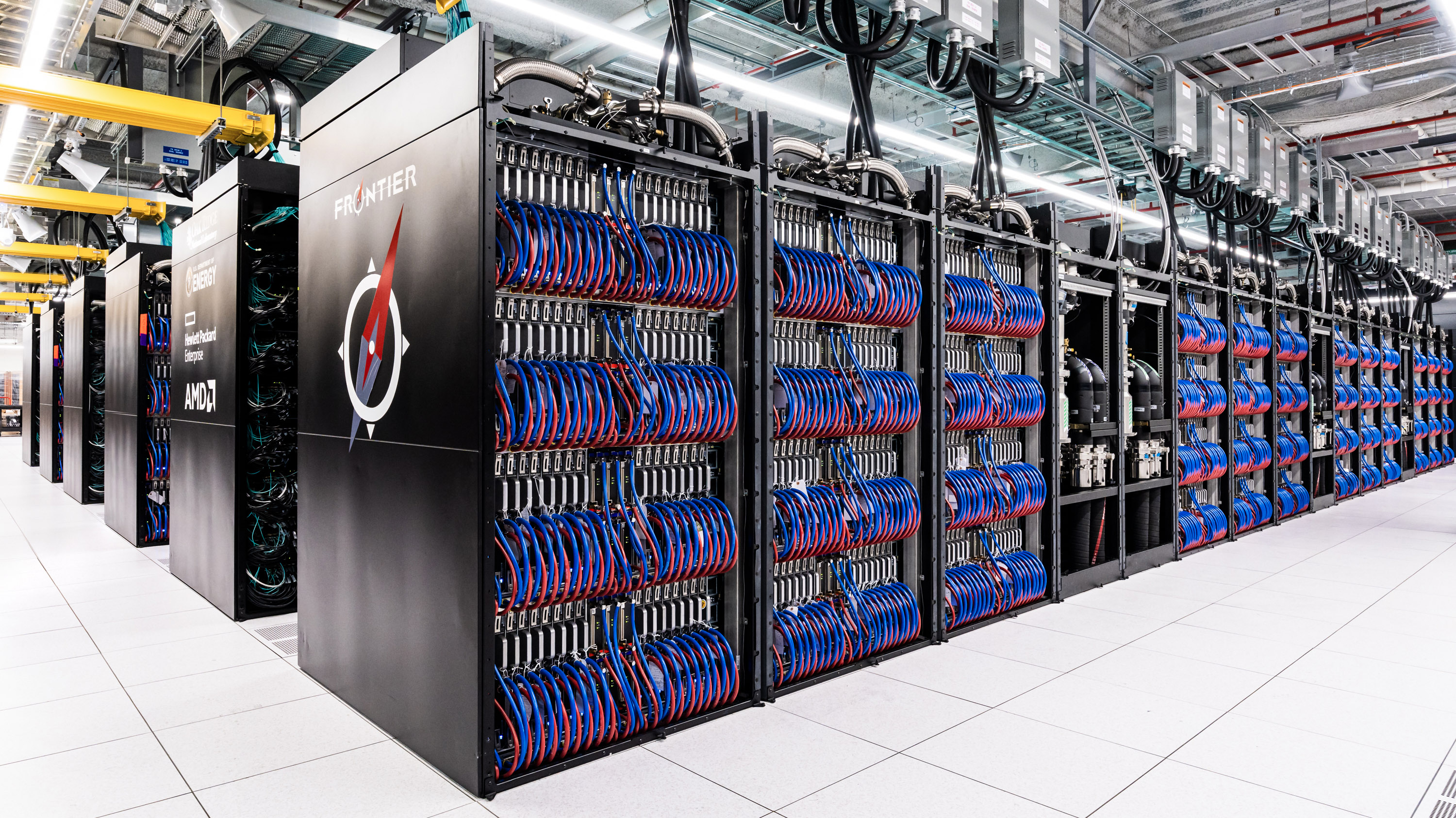 Long rows of supercomputers with the name "Frontier" visible on the end